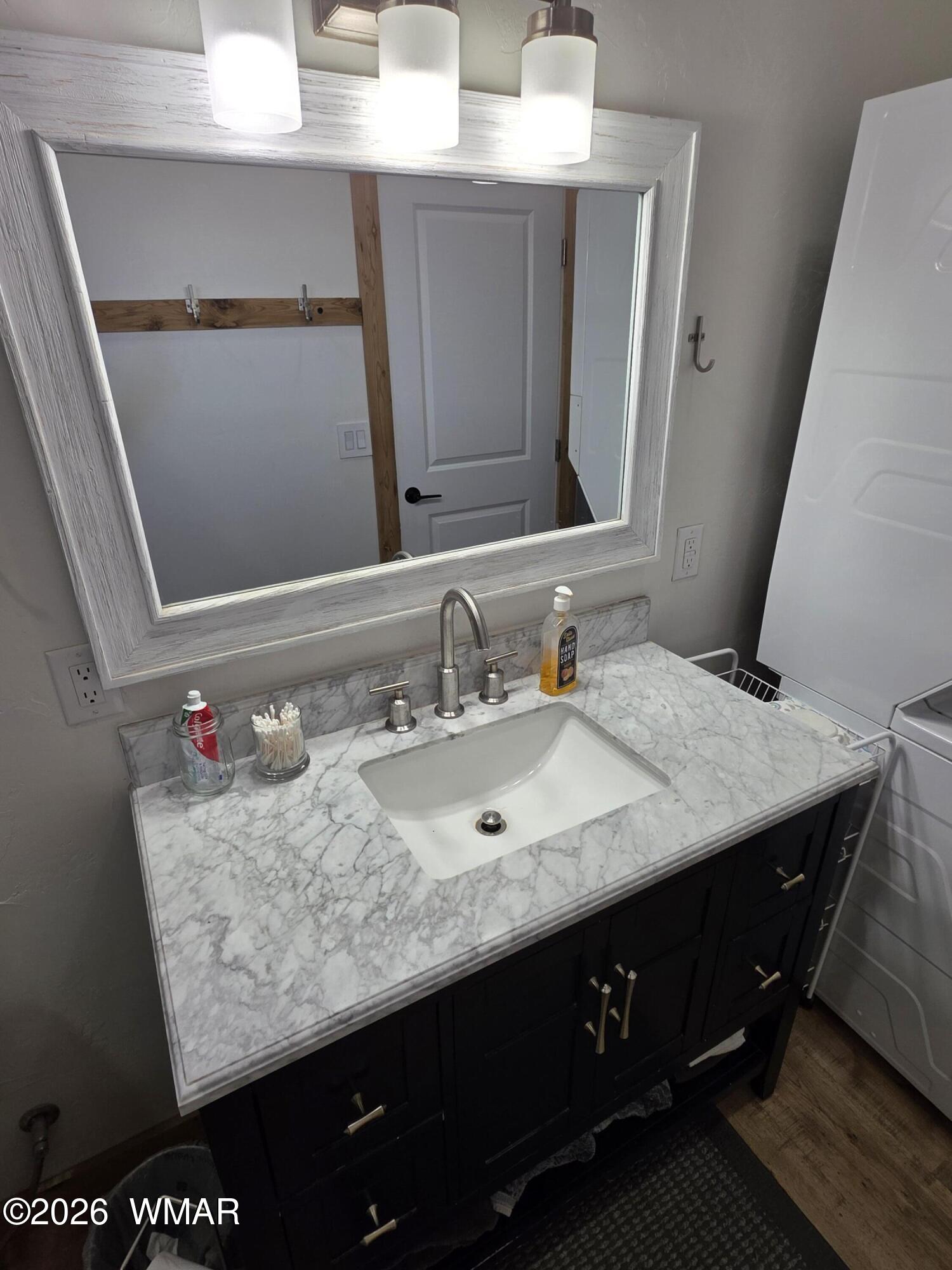 5057 Churchill Road Snowflake, AZ 85937 - Photo 76 of 115 a bathroom with a granite countertop sink a mirror and vanity
