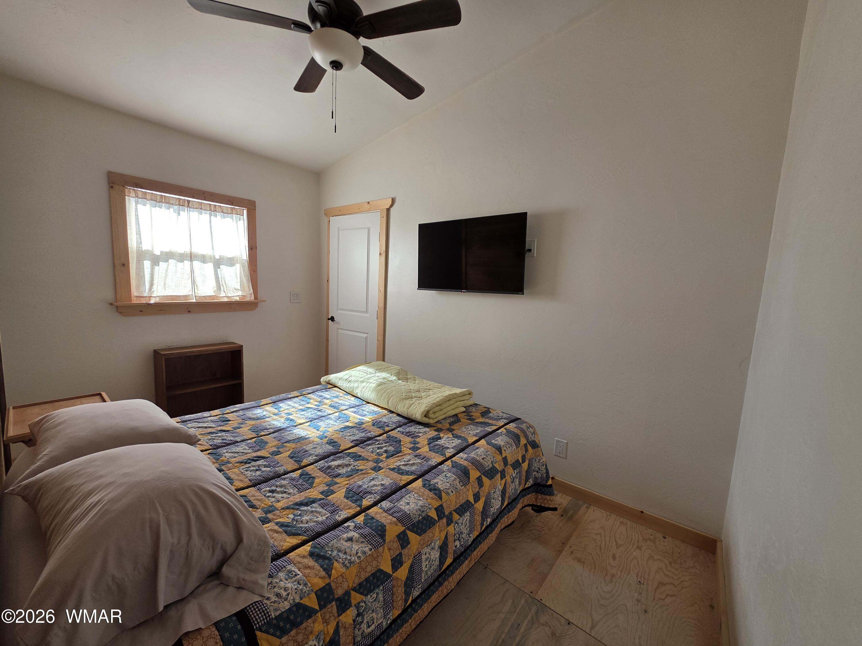 5057 Churchill Road Snowflake, AZ 85937 - Photo 82 of 115 a bedroom with a bed and a flat screen tv