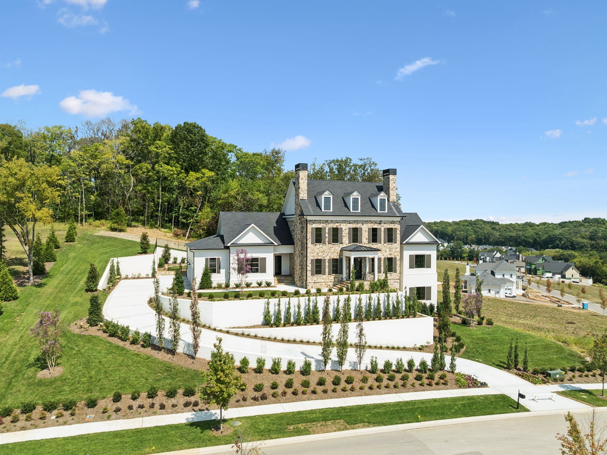 8101 Heirloom Boulevard College Grove, TN 37046 - Photo 3 of 81 a front view of a house with a yard table and chairs