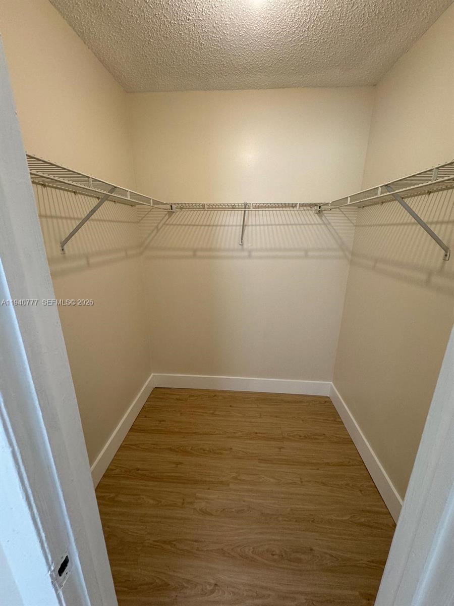 11307 Southwest 200th Street, Unit 310B Miami, FL 33157 - Photo 9 of 14 a view of a room with racks on the wall