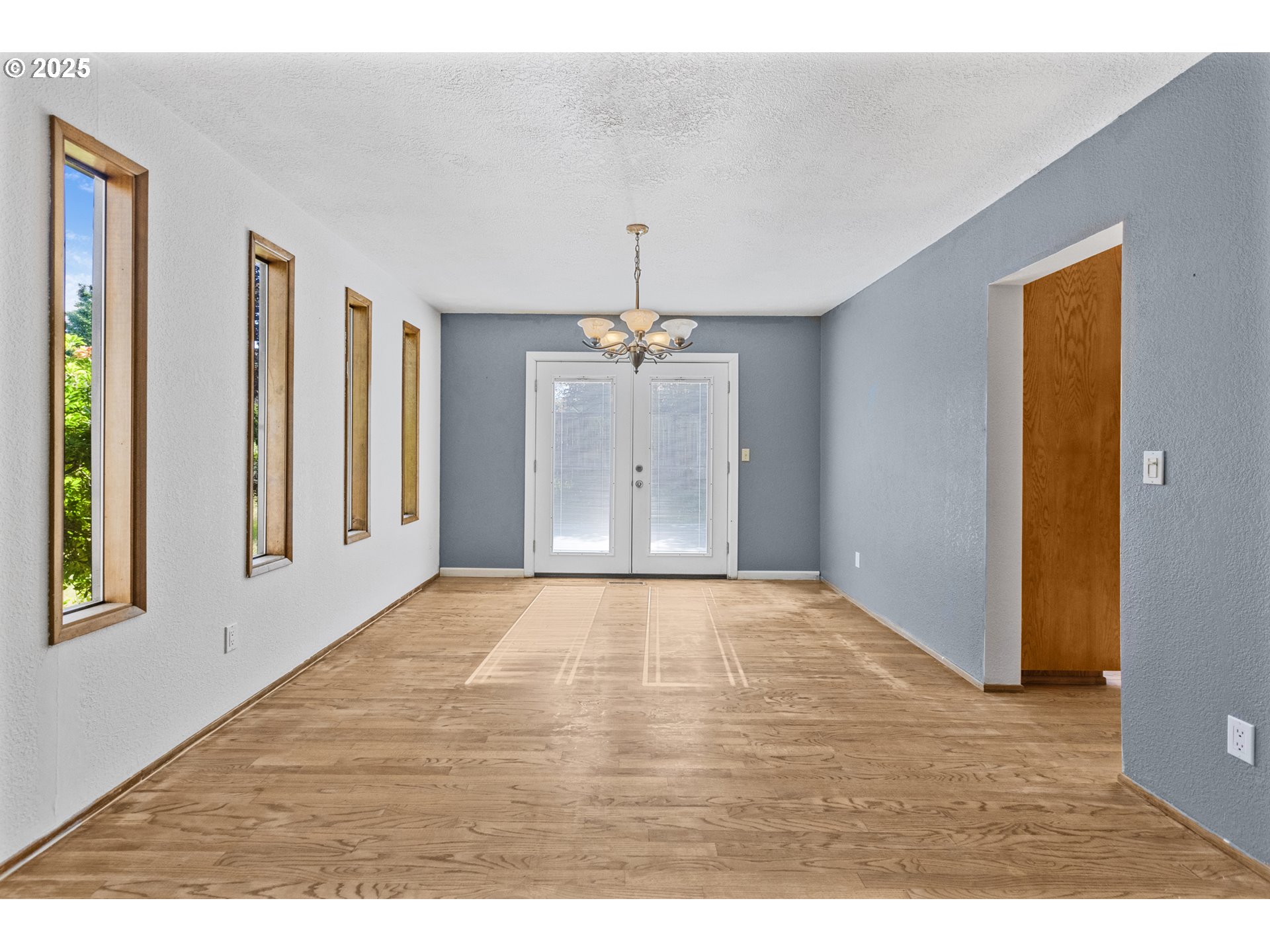2641 Northwest Crocker Lane Albany, OR 97321 - Photo 17 of 47 a view of an empty room with window and wooden floor