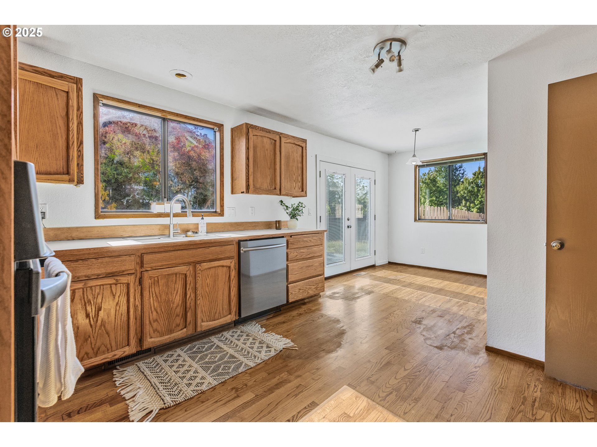 2641 Northwest Crocker Lane Albany, OR 97321 - Photo 18 of 47 a view of a kitchen with a sink and dishwasher with wooden floor