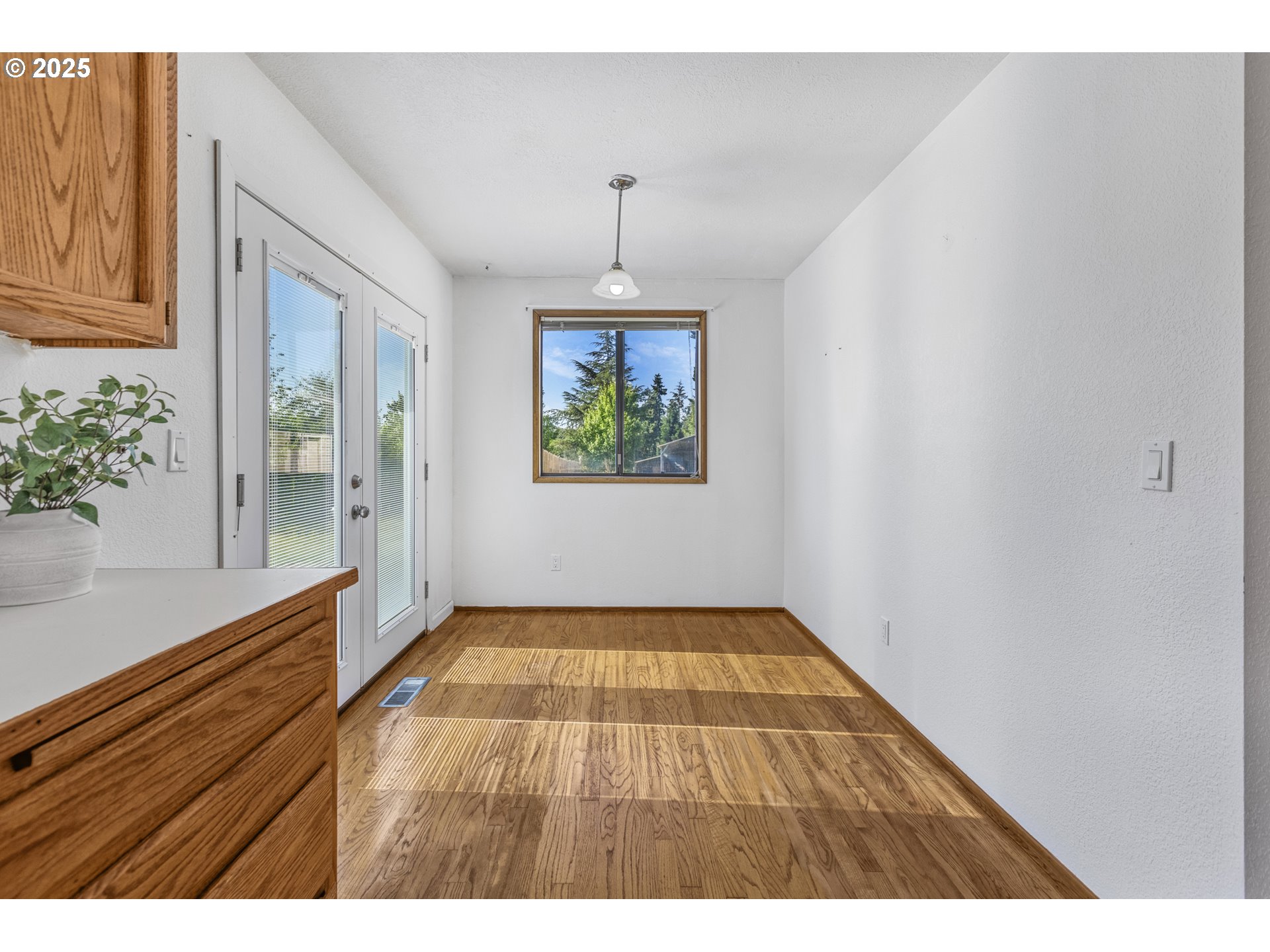 2641 Northwest Crocker Lane Albany, OR 97321 - Photo 20 of 47 a view of an empty room with window and wooden floor