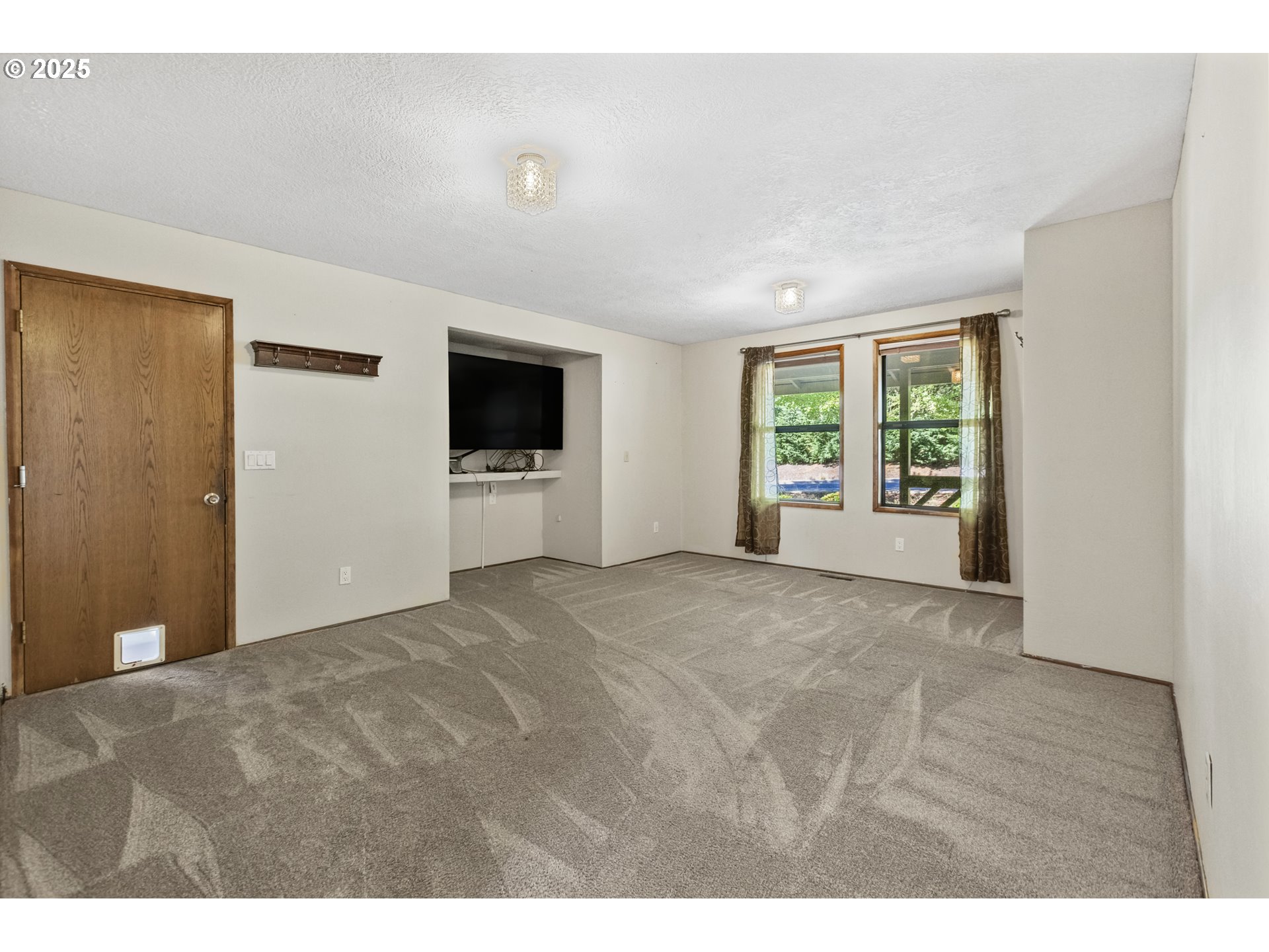 2641 Northwest Crocker Lane Albany, OR 97321 - Photo 23 of 47 a view of an empty room with a window and a kitchen