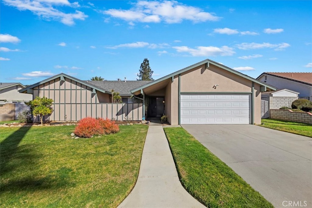 2843 Jane Street Riverside, CA 92506 - Photo 1 of 1 a front view of a house with a yard and garage