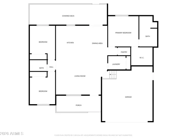 a view of a terrace that has wooden fence and trees in the background