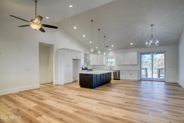 a large kitchen with stainless steel appliances kitchen island granite countertop a large island in the center