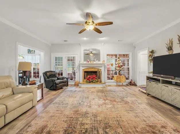 a living room with furniture a fireplace and a flat screen tv