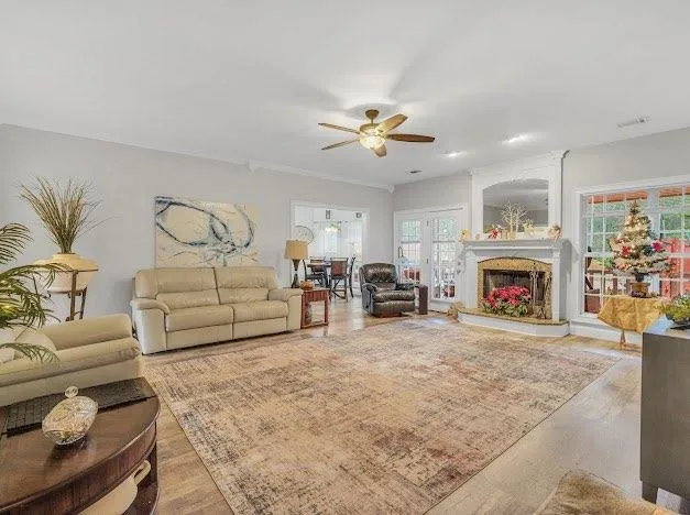 a living room with furniture fireplace and window