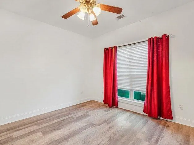 a view of a room with window and wooden floor