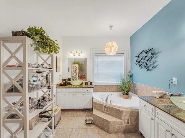 a bathroom with a sink a mirror and a bathtub