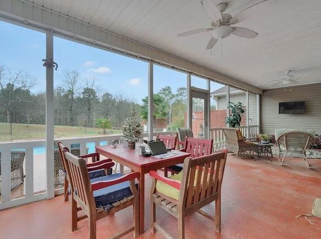 a living room with furniture a rug and a window