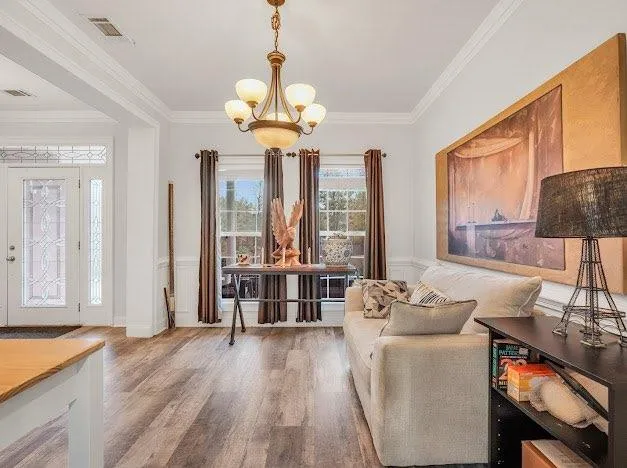 a living room with furniture and a chandelier