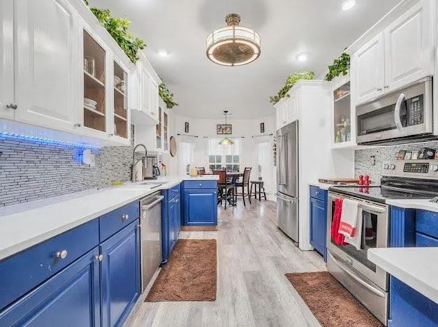 a kitchen with stainless steel appliances granite countertop a stove refrigerator and a wooden cabinets