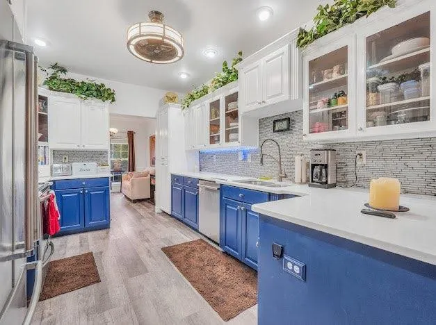 a kitchen with stainless steel appliances granite countertop a sink dishwasher stove and cabinets
