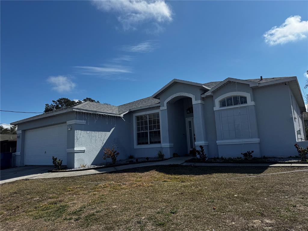 10130 Spring Hill Drive Spring Hill, FL 34608 - Photo 1 of 33 a front view of a house with garden