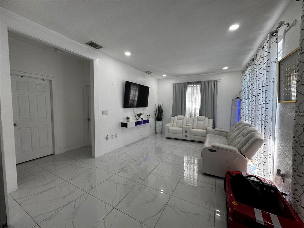 10130 Spring Hill Drive Spring Hill, FL 34608 - Photo 12 of 33 a living room with furniture and a flat screen tv