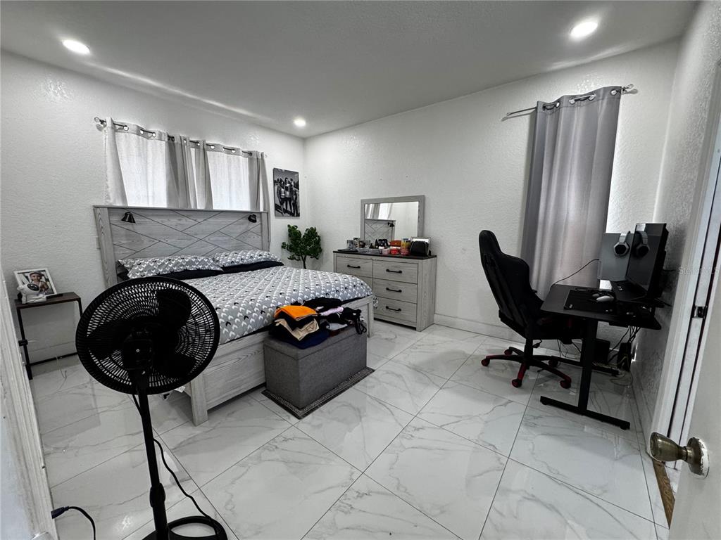 10130 Spring Hill Drive Spring Hill, FL 34608 - Photo 13 of 33 a living room with furniture and a chandelier