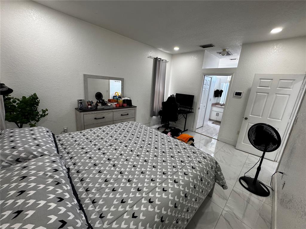 10130 Spring Hill Drive Spring Hill, FL 34608 - Photo 14 of 33 a bedroom with bed and furniture