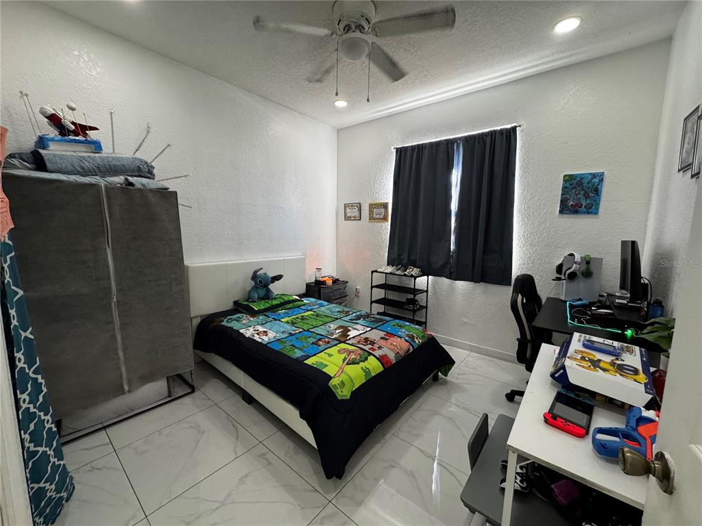 10130 Spring Hill Drive Spring Hill, FL 34608 - Photo 16 of 33 a room with furniture a rug and gym equipment