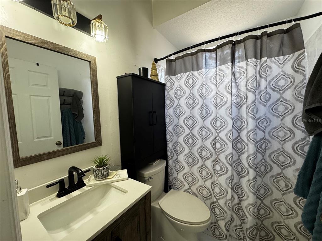 10130 Spring Hill Drive Spring Hill, FL 34608 - Photo 17 of 33 a bathroom with a sink toilet and shower