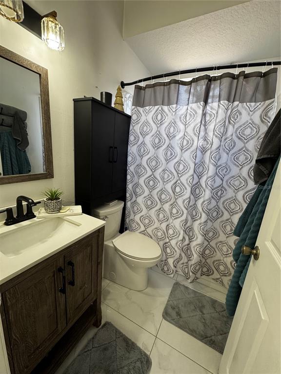 10130 Spring Hill Drive Spring Hill, FL 34608 - Photo 18 of 33 a bathroom with a granite countertop sink toilet and shower