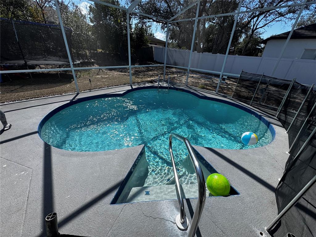 10130 Spring Hill Drive Spring Hill, FL 34608 - Photo 22 of 33 a view of a swimming pool with a patio and plants