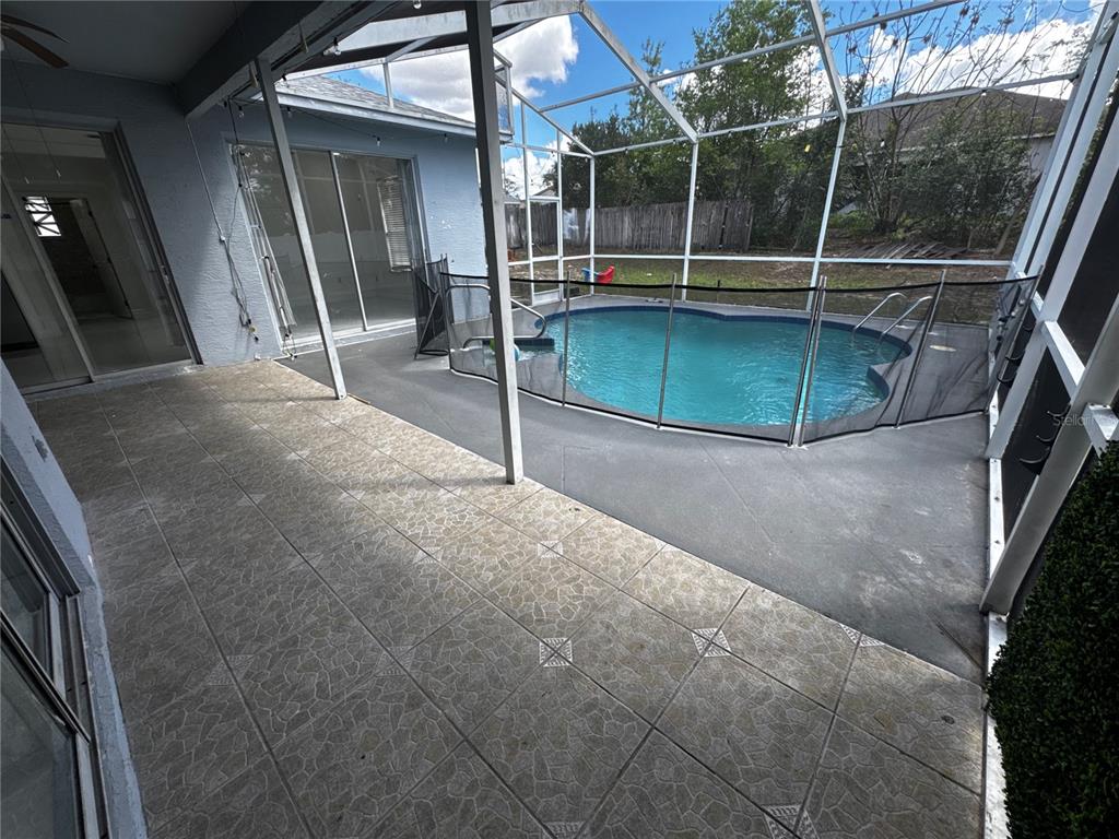 10130 Spring Hill Drive Spring Hill, FL 34608 - Photo 27 of 33 a view of a room with wooden floor and iron fence