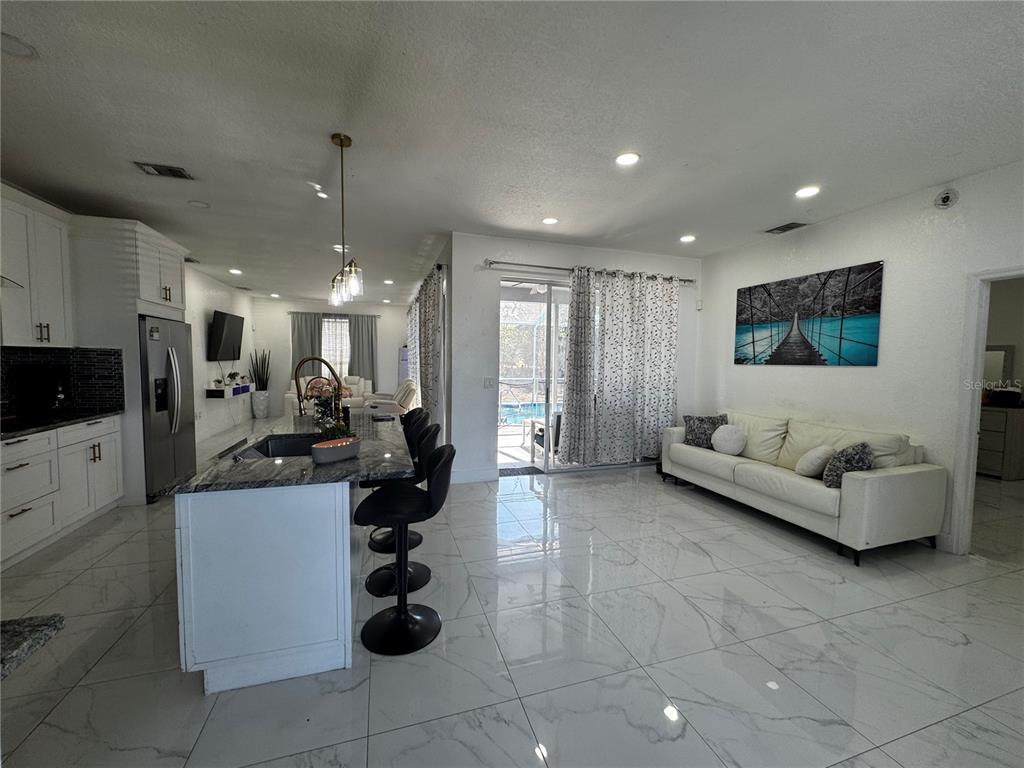 10130 Spring Hill Drive Spring Hill, FL 34608 - Photo 6 of 33 a living room with furniture and kitchen view