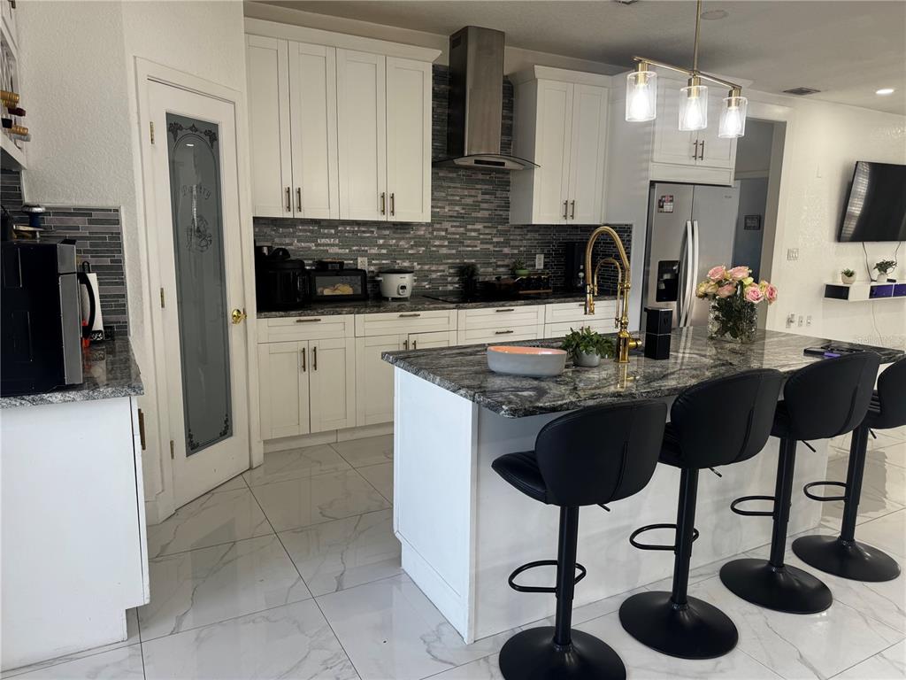 10130 Spring Hill Drive Spring Hill, FL 34608 - Photo 10 of 33 a kitchen with stainless steel appliances granite countertop a sink a stove and a refrigerator