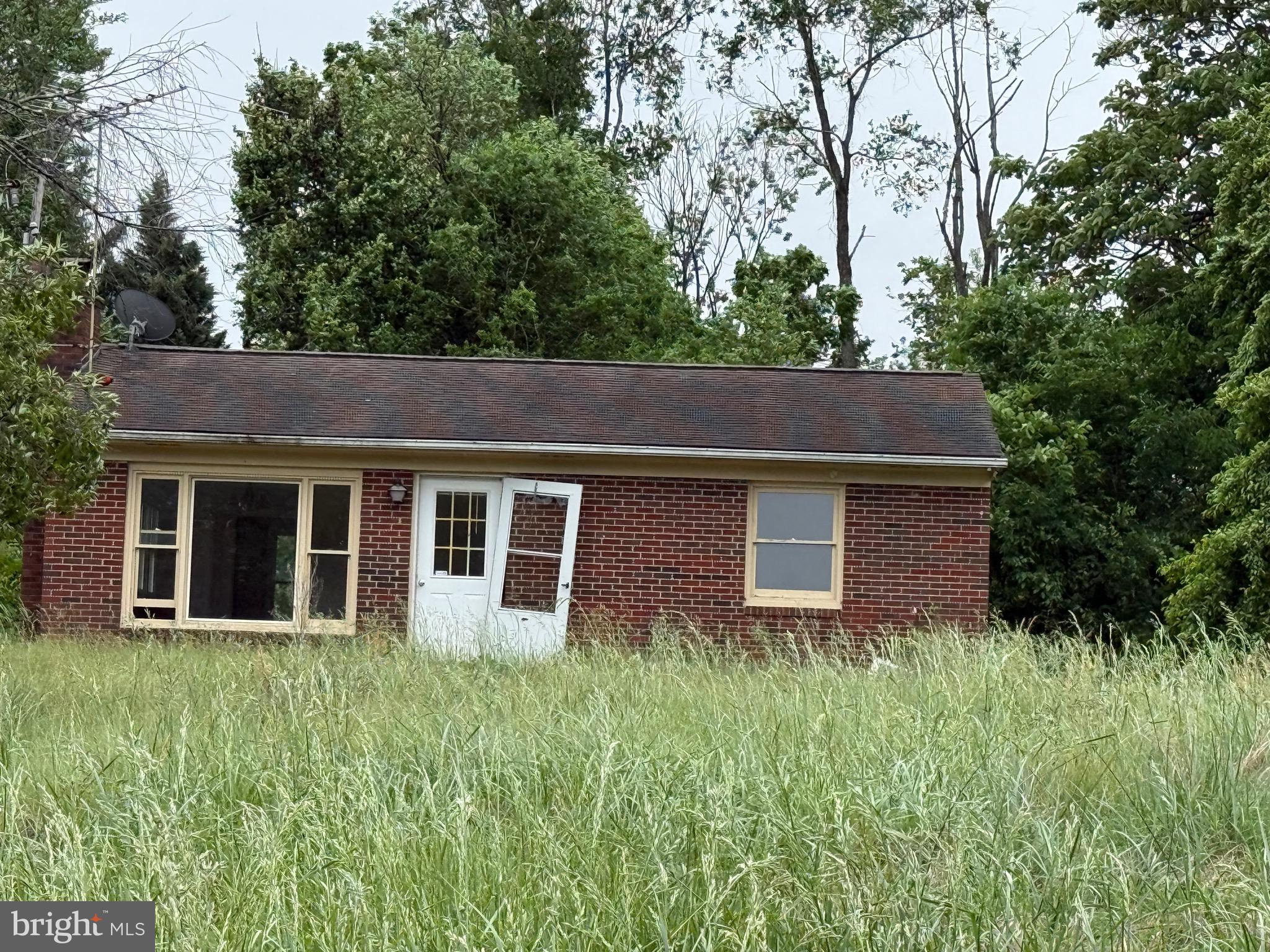 14220 Chestnut Fork Road Culpeper, VA 22701 - Photo 1 of 1 a view of a house with large window and large trees