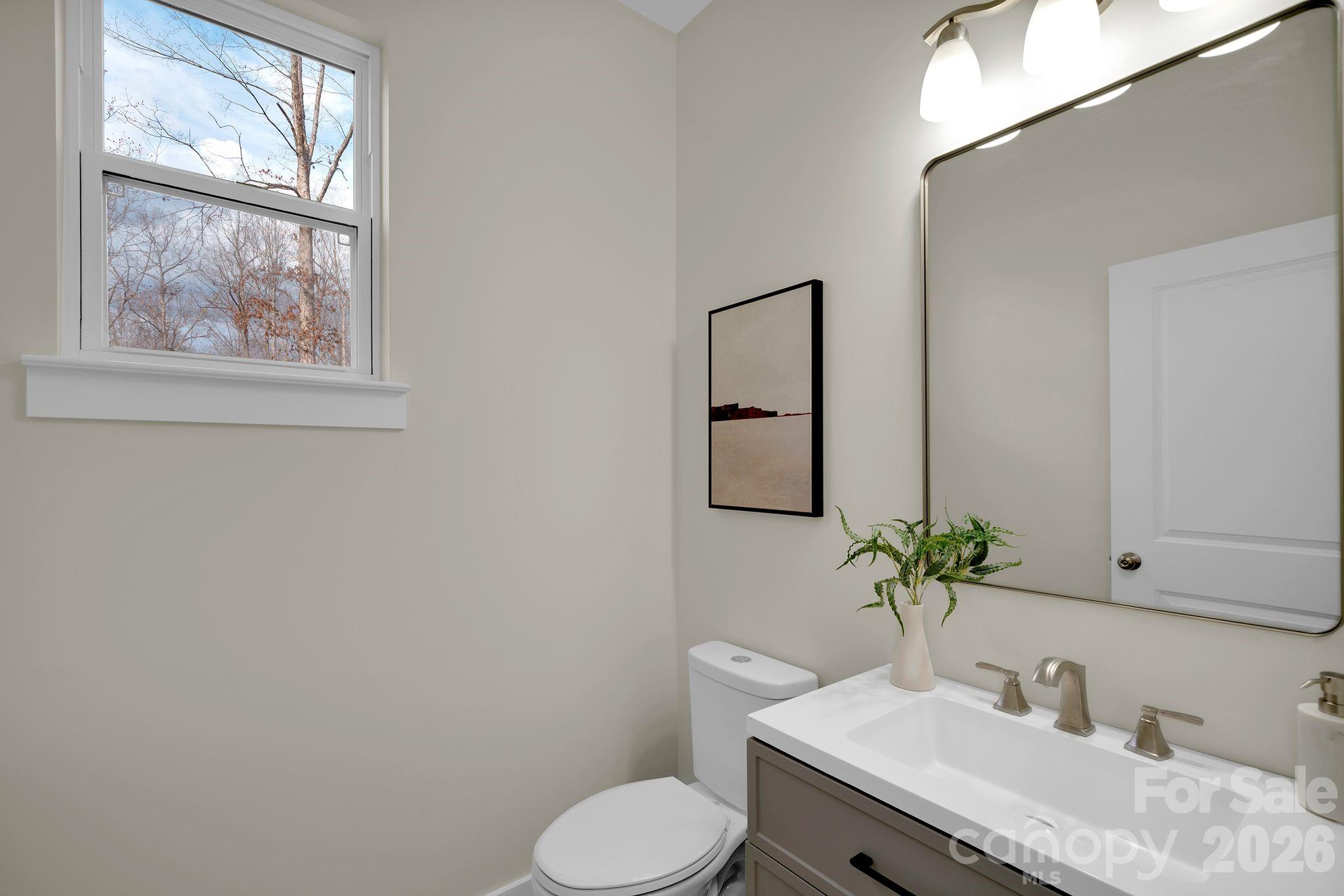 9050 Unity Church Road Mooresville, NC 28115 - Photo 4 of 32 a bathroom with a granite countertop sink and a mirror