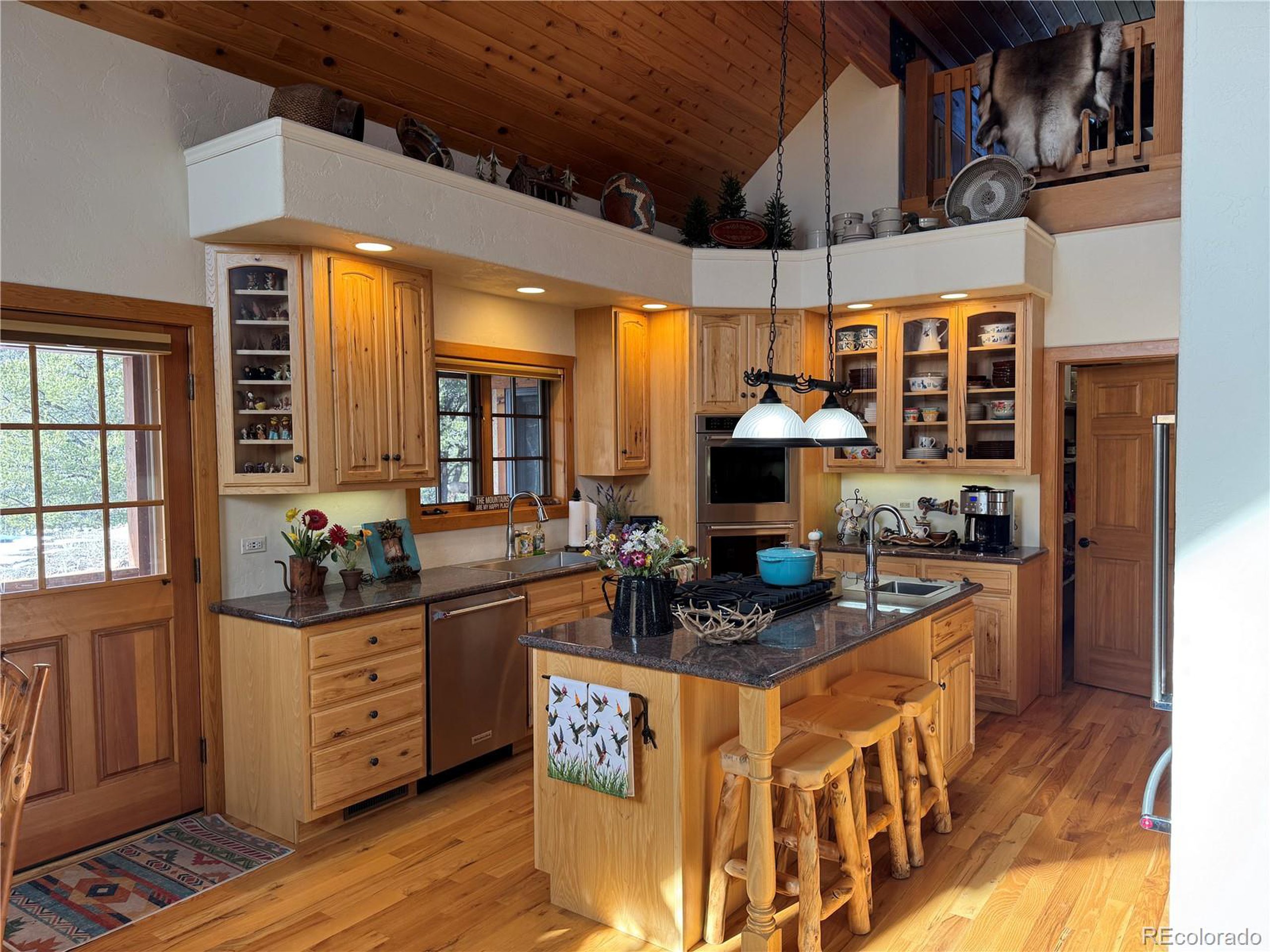 200 Moffat Road Cotopaxi, CO 81223 - Photo 25 of 42 a kitchen with stainless steel appliances kitchen island granite countertop a stove and cabinets
