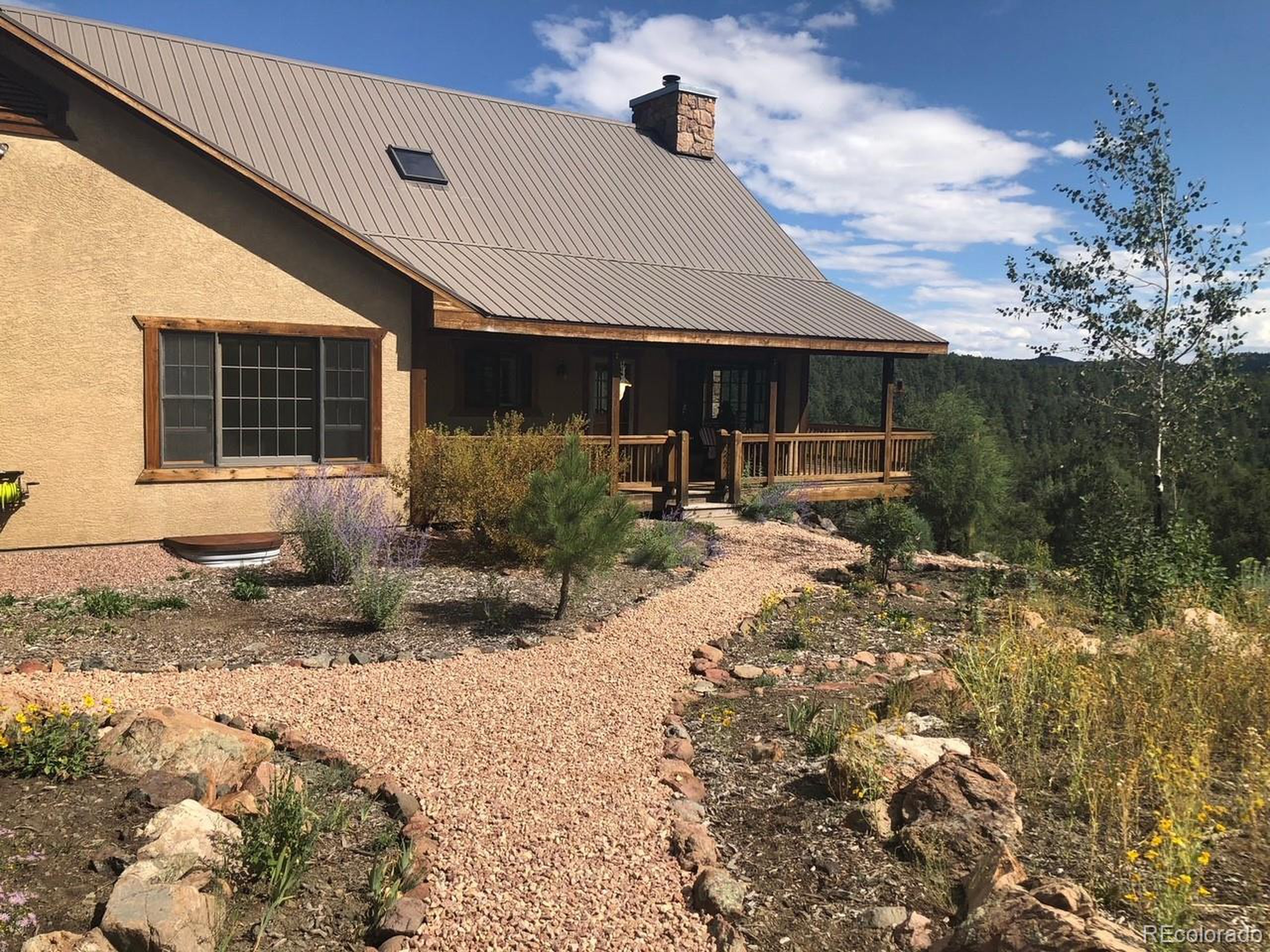 200 Moffat Road Cotopaxi, CO 81223 - Photo 35 of 42 a backyard of a house with garden and outdoor seating