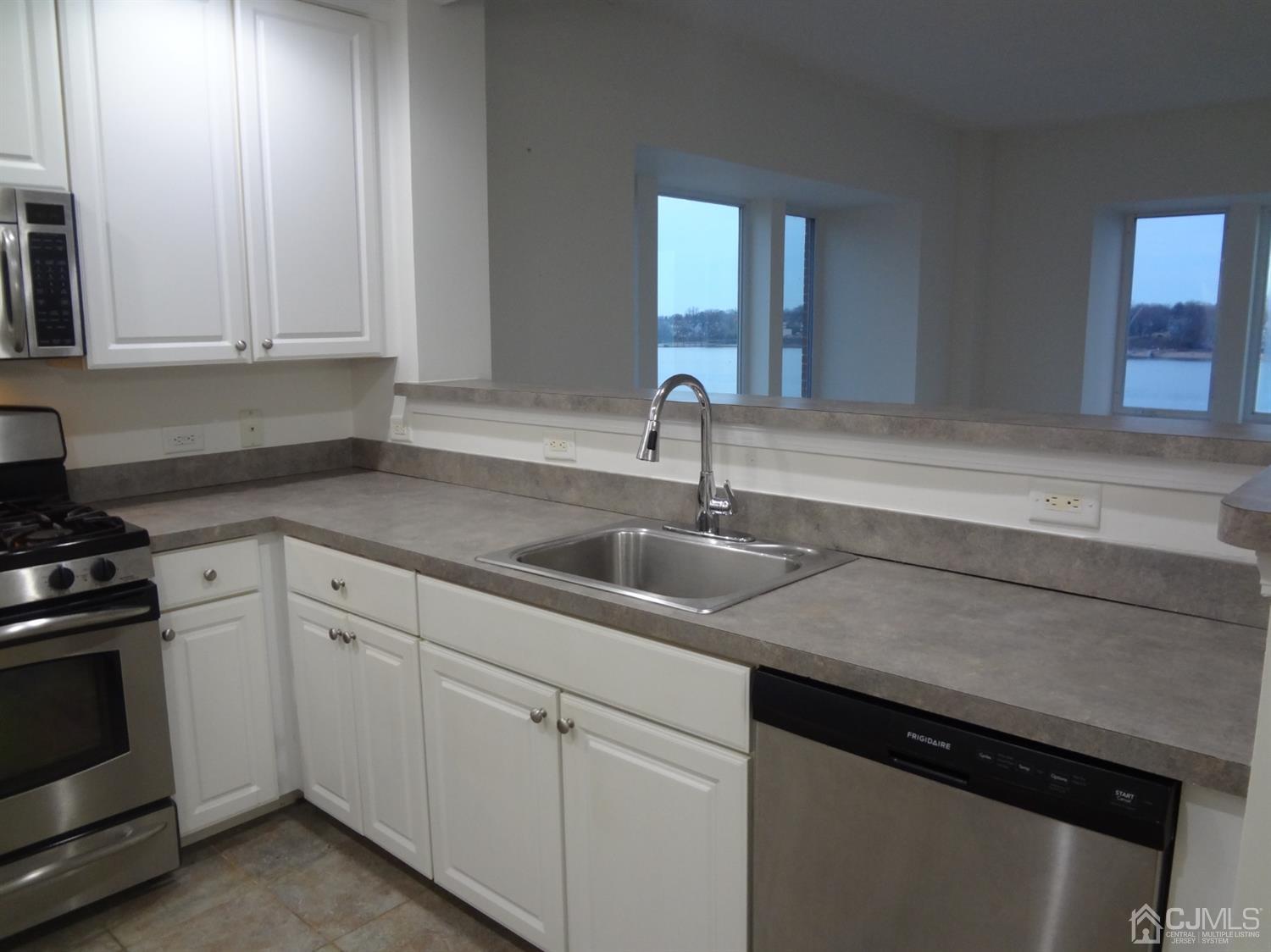 358 Rector Street, Unit 511 Perth Amboy, NJ 08861 - Photo 11 of 29 a kitchen with a sink and cabinets
