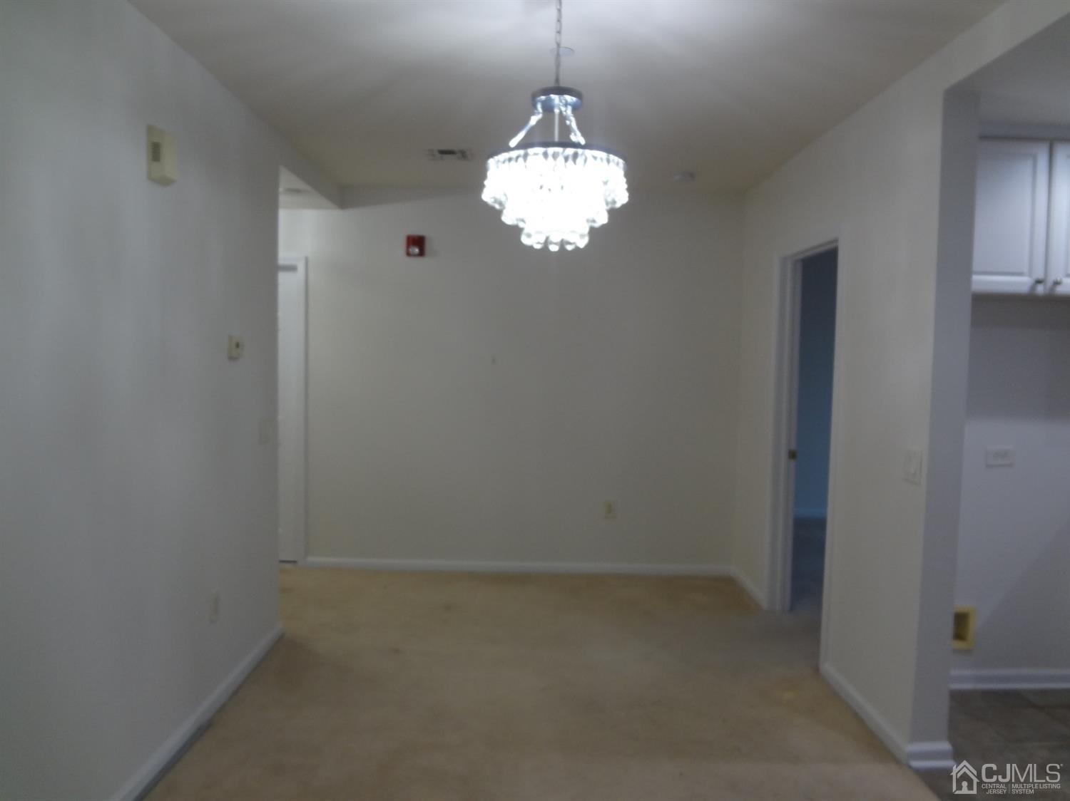 358 Rector Street, Unit 511 Perth Amboy, NJ 08861 - Photo 17 of 29 a room with a chandelier fan and a window