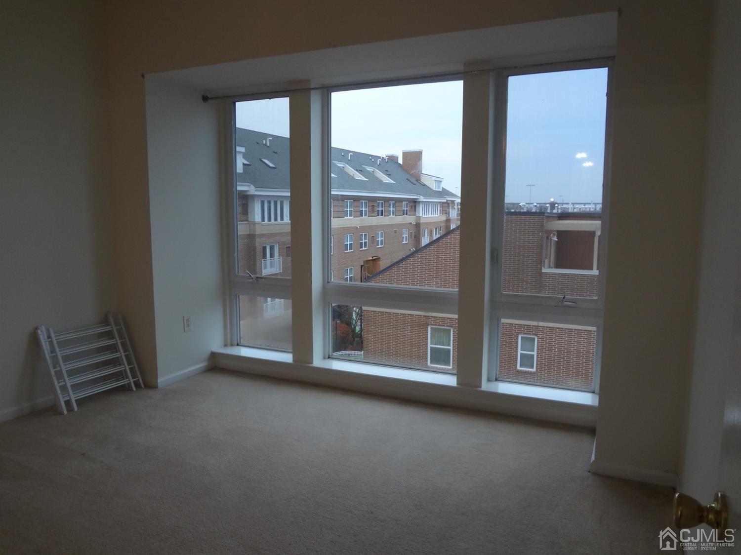 358 Rector Street, Unit 511 Perth Amboy, NJ 08861 - Photo 19 of 29 an empty room with windows
