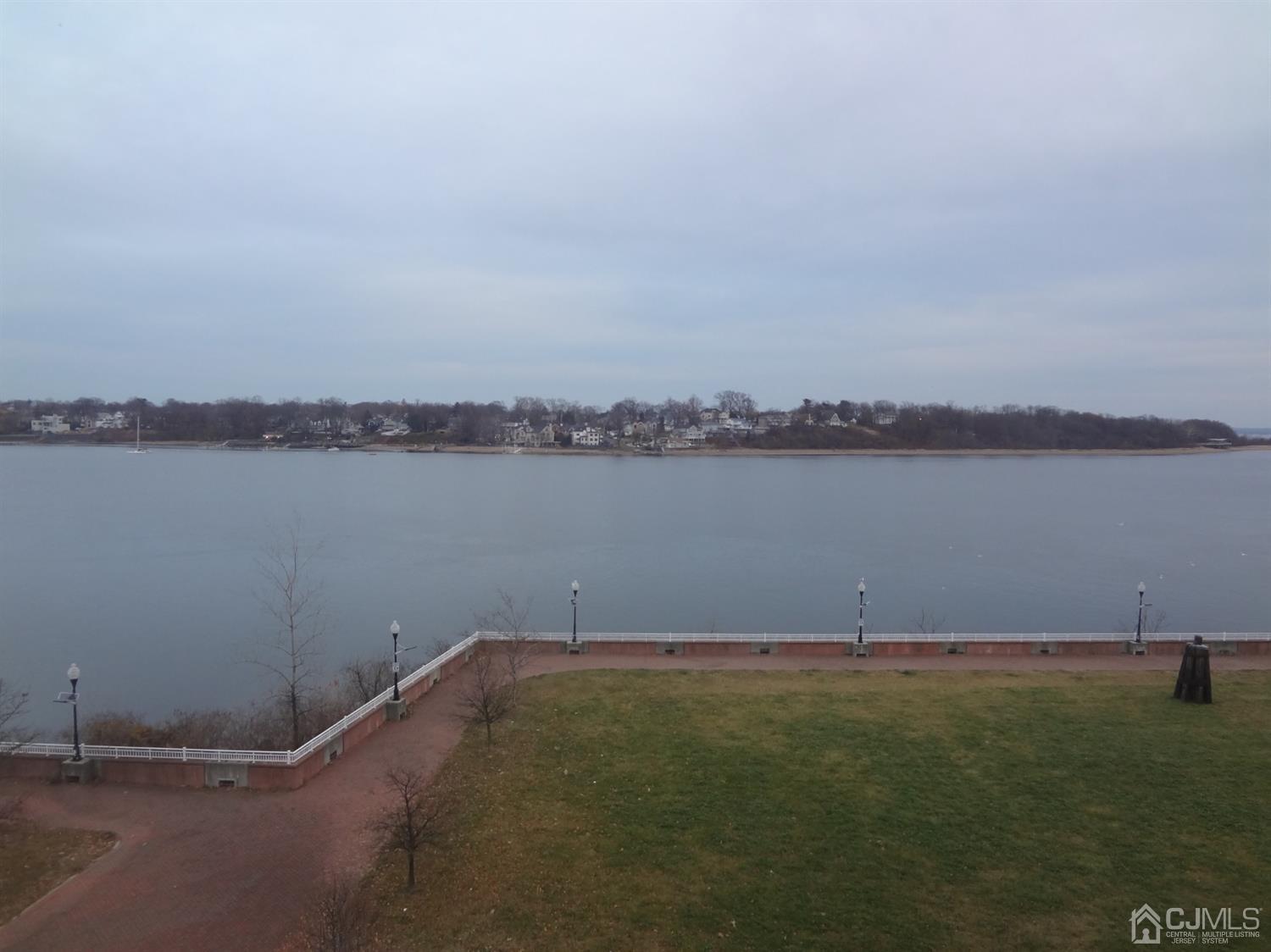 358 Rector Street, Unit 511 Perth Amboy, NJ 08861 - Photo 21 of 29 a view of a lake with houses in the back