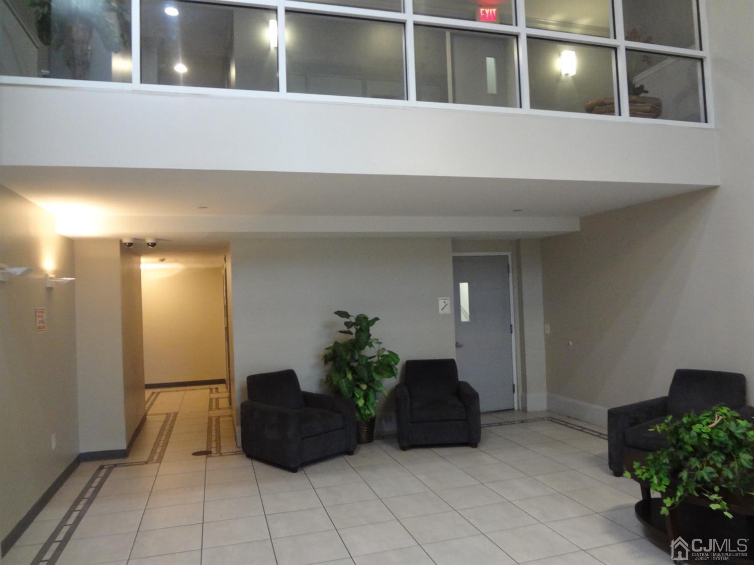 358 Rector Street, Unit 511 Perth Amboy, NJ 08861 - Photo 4 of 29 a living room with furniture and potted plant