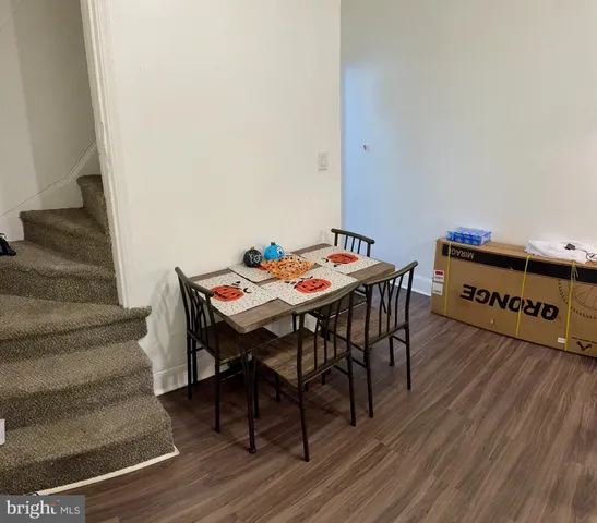 a dining room with furniture and wooden floor