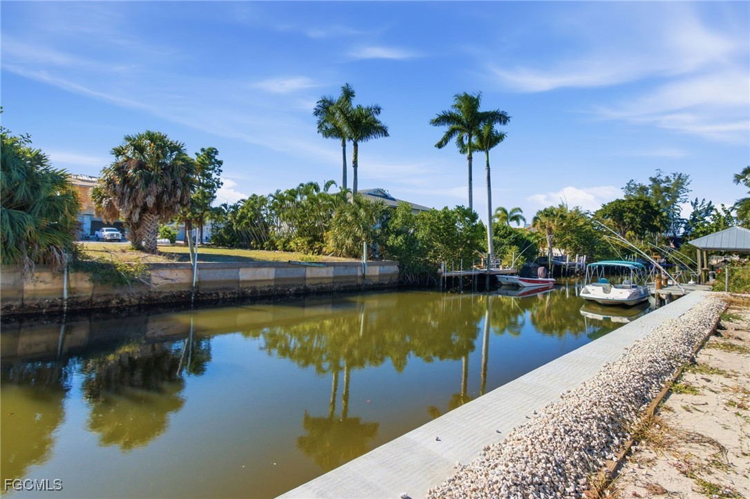 2754 Shoreview Drive Naples, FL 34112 - Photo 12 of 18 a view of a lake with a house in the background