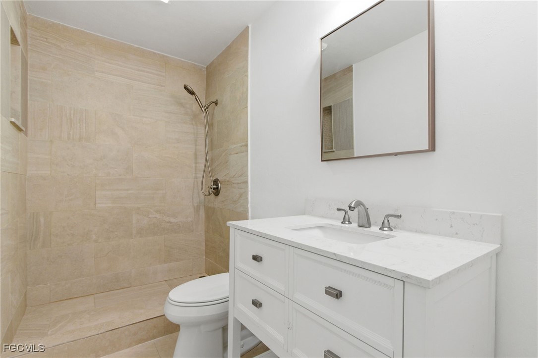 2754 Shoreview Drive Naples, FL 34112 - Photo 6 of 18 a bathroom with a sink toilet and shower