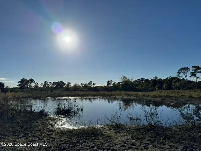 a view of a lake with houses in the back