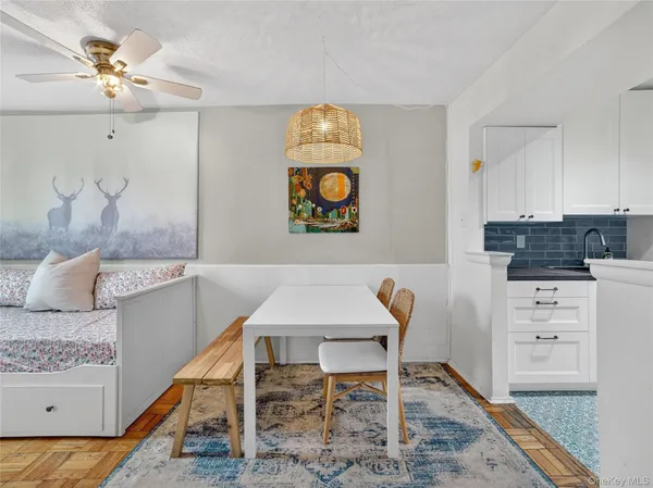 a view of a kitchen with table and chairs