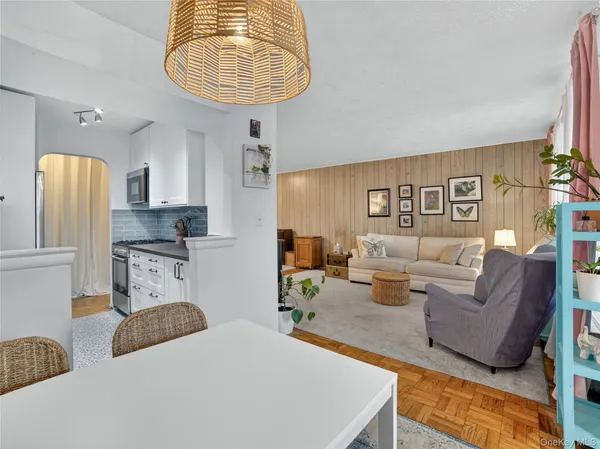 a living room with furniture a couch and a chandelier