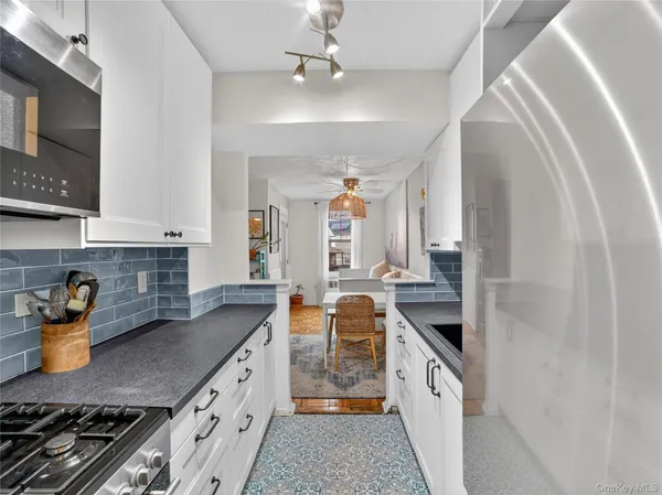 a kitchen with stainless steel appliances granite countertop a stove and a sink