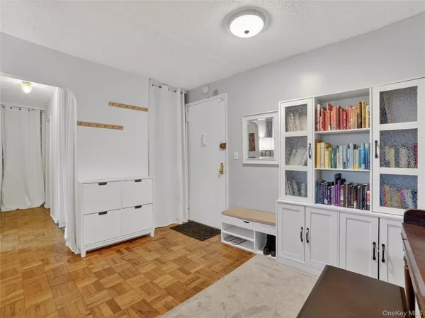 a bedroom with furniture and a book shelf