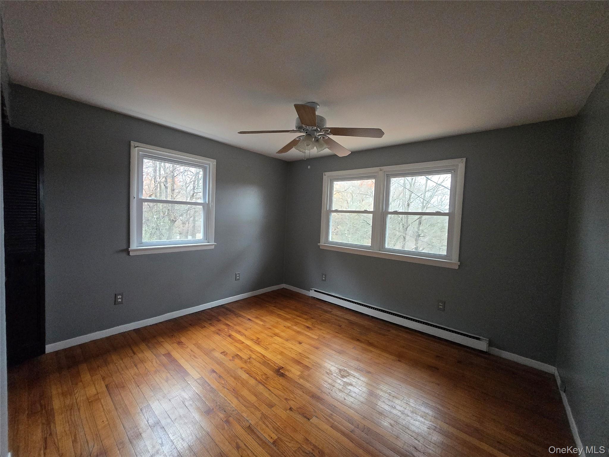 43 Glenmere Homesites Road Florida, NY 10921 - Photo 10 of 30 Spare room with baseboard heating, hardwood / wood-style floors, and a ceiling fan
