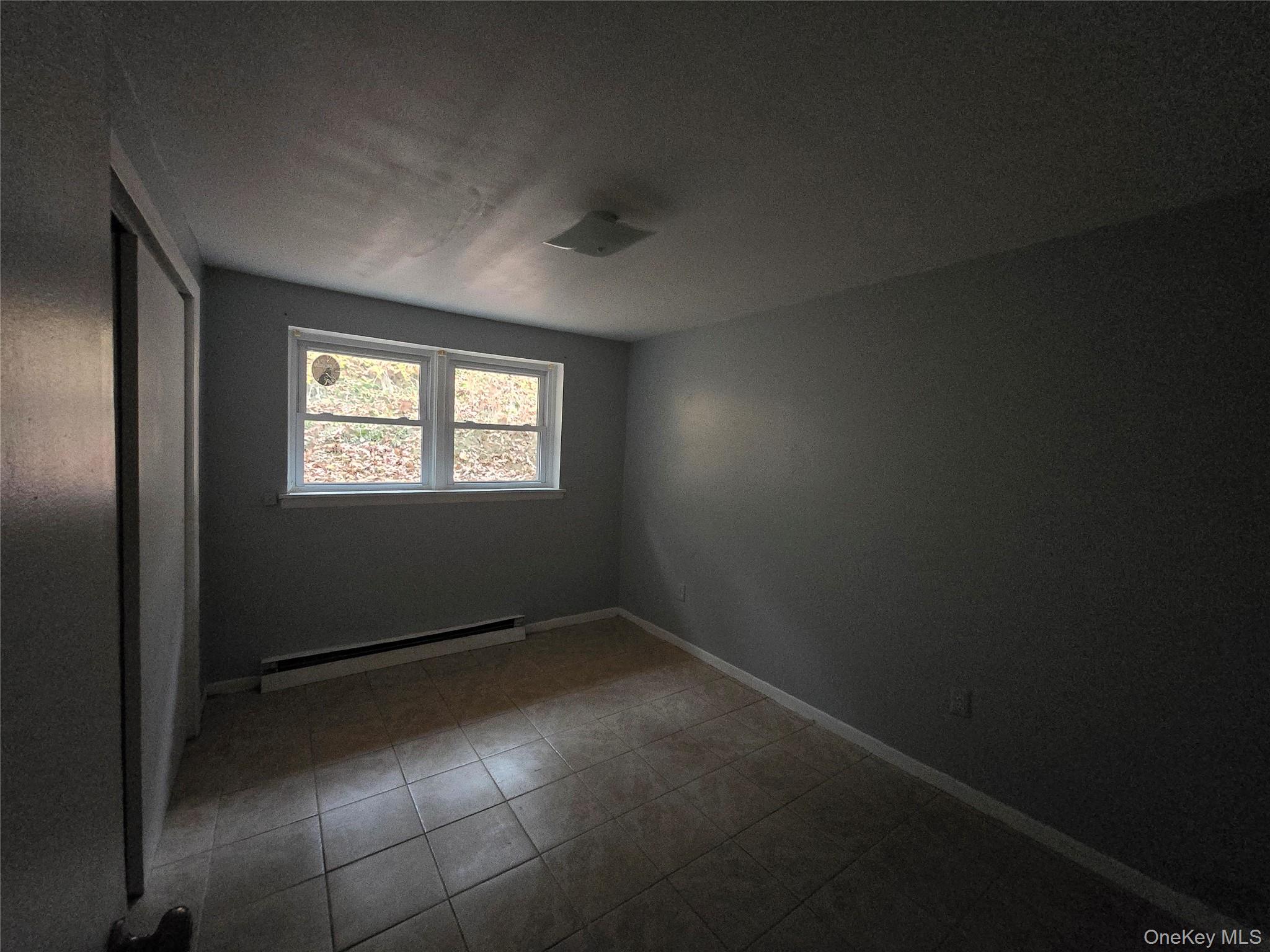 43 Glenmere Homesites Road Florida, NY 10921 - Photo 20 of 30 Empty room featuring baseboard heating and light tile patterned floors