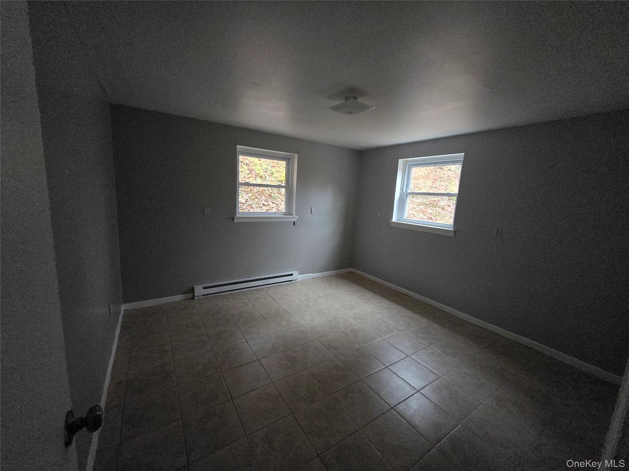43 Glenmere Homesites Road Florida, NY 10921 - Photo 22 of 30 Tiled spare room featuring baseboard heating and a textured ceiling